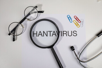 Hantavirus Alert Paper with Magnifying Glass on Doctor’s Desk – Medical Surveillance Scene