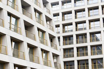 Modern residential apartment building. Housing complex with many balconies. Urban architecture with...