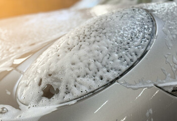 Process of spraying foam on the auto body in the station. Second phase of detailing washing in car...