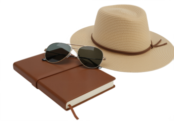 Stylish Travel Setup with Leather Notebook, Straw Hat, and Aviator Sunglasses Against White Background