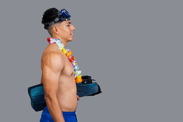 Swimmer wearing diving mask and hawaiian lei holding flippers getting ready for vacation