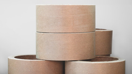 Stack of cardboard packaging tubes, corners brown and arranged in a row as background templates of...