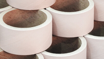 Stack of cardboard packaging tubes, corners brown and arranged in a row as background templates of...