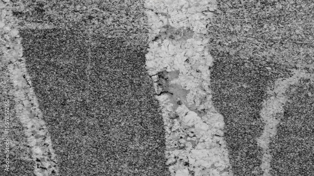 Poster Grey and white surface with a crack in it. crack is in the middle of the surface, and it is quite deep. surface is made of stone or concrete, and it has a rough texture