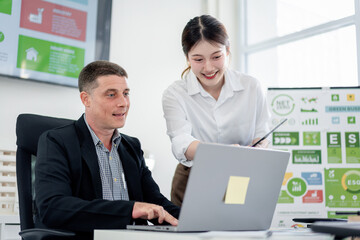 Obraz premium Business Professionals Collaborating on Green Initiatives ESG Strategy Reducing Carbon Emissions in a Modern Office Environment