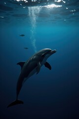 Obraz premium A black dolphin swimming calmly in deep blue ocean, sunlight filtering through the water, surrounded by small fish. The mood is peaceful and serene