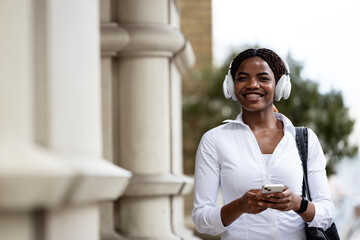 Portrait of happy smiling black woman with smart phone.