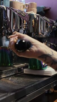 hands of a tattooed eatery girl making coffee