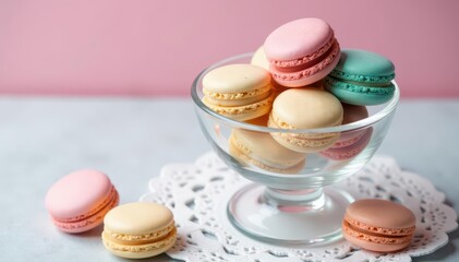 Obraz premium Delicate pastel macarons in a clear glass bowl atop white lace , colorful macarons, beautiful, close up
