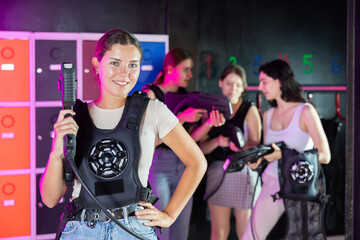 Break in game - portrait of a happy girl with a gun for playing laser tag