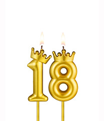 Golden number 18 birthday candle on white background