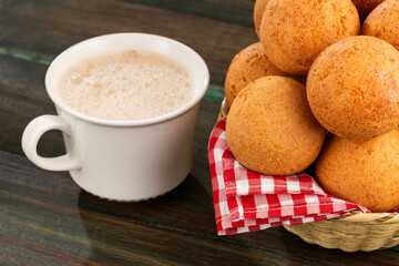 Fried cheese buñuelos accompanied by a hot chocolate drink - Typical Colombian cuisine