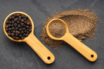 Black peppercorns in a wooden spoon - Piper nigrum