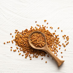 Organic fenugreek seeds in spoon - Trigonella foenum - graecum