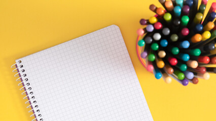 School supplies, stationery such as pencils and notebook on a yellow bright background. Back to school banner.