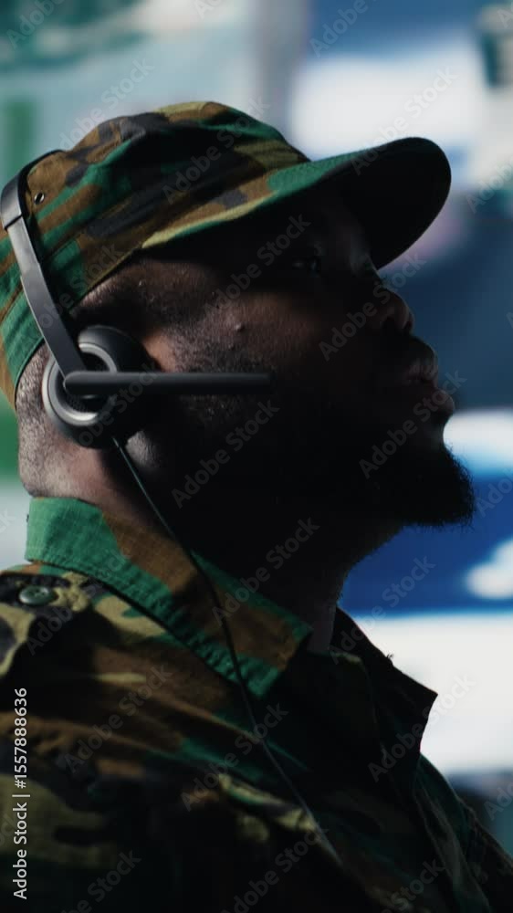Poster vertical video black soldier guiding troops with satellite coordinates to create tactics, high tech 