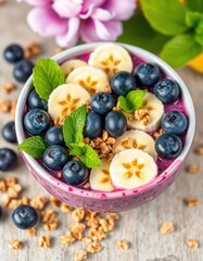 Vibrant acai bowl topped with blueberries, banana slices & granola, breakfast, energy
