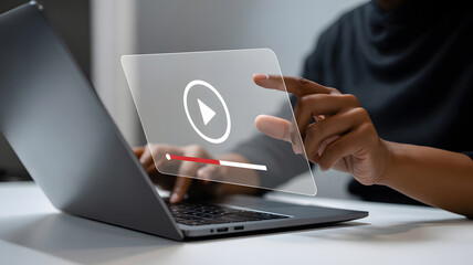 Digital streaming on a laptop presents an African American person pressing a play button, offering entertainment content and a modern online video experience for the user.