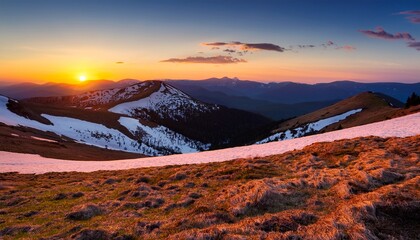 sunset in the spring mountains snowy hills and high peaks glowing by setting sun landscape photography