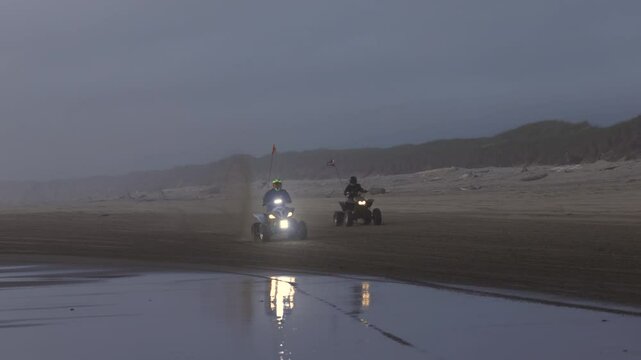 atv's doing a wheelie on the beach