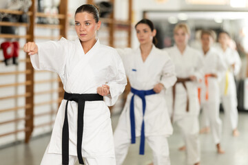 Kata karate teacher conducts classes and performs movements and fighting techniques together with...