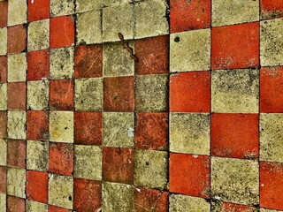 a gridded background of sidewalks in the city of Granada, Nicaragua, the dirty ground, the red and white tiles