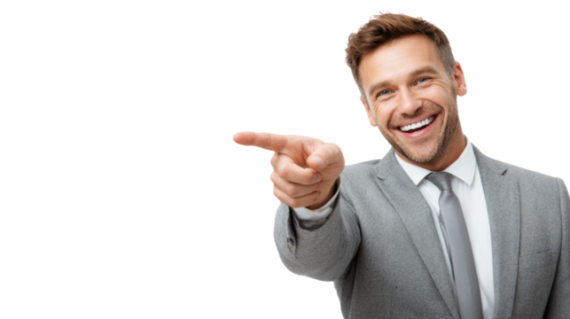 A cheerful businessman in a gray suit pointing with a smile, isolated on a white background.