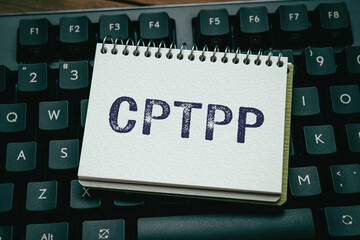 There is notebook with the word CPTPP. It is an abbreviation for Comprehensive and Progressive...