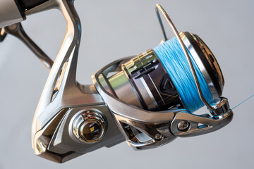 Extreme Closeup of a Fishing Reel Spooled With Blue Fishing Line