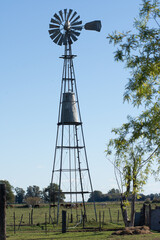 Scenic Windmill in a Lush Green Field Under Blue Sky