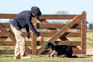 Country Man with Beret Opening Gate for His Dog on a Rural Farm