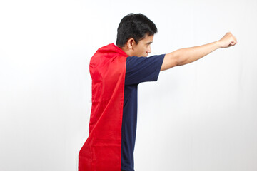 Asian man excited wearing red and white flag on his body facing sideways raising his hand while...