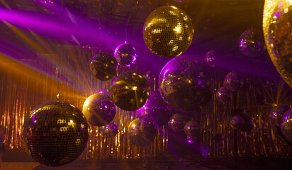 disco mirror balls with texture in the rays of multi-colored spotlights for music show background...
