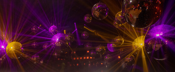 disco mirror balls with texture in the rays of multi-colored spotlights for music show background...