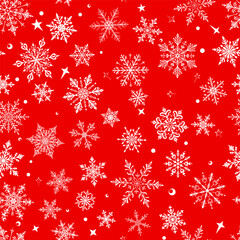Christmas seamless pattern with big and small snowflakes in various designs, white on red background.
