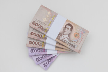 Banknote thai baht, paper bank, price of one thousand, stacked sets isolated on white background. 1000, 500 Bath bank note for shopping, paying bills, taxes, debt, insurance, financial, investment.