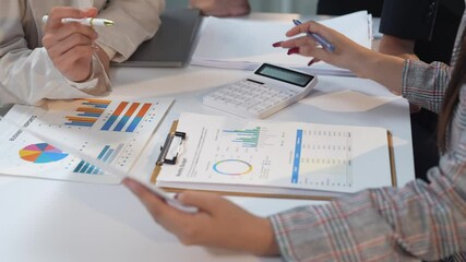 Businesswomen team working with financial reports using calculator - Powered by Adobe