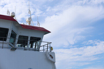 View of a ferry bridge against a clear blue sky with scattered clouds during daytime