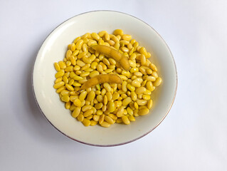 Yellow soybean and their pods on white background. 