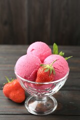 Tasty sorbet with strawberries and mint served on wooden table, closeup