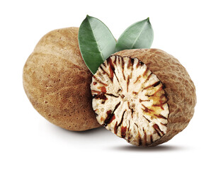 Nutmeg seeds with green leaves on white background. Aromatic spice