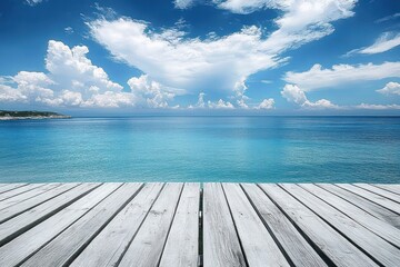 Fototapeta premium Wooden pier extending out over calm blue ocean water under a bright sky filled with fluffy white clouds