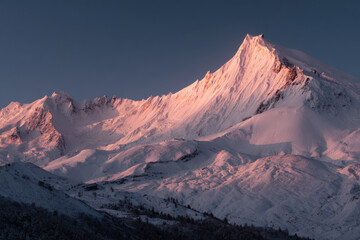 breathtaking view of mount manaslu illuminated by ultrabright light of setting sun