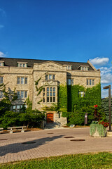 10 Aug 2024 - University of Guelph, ON, Canada. A section of the administrative building covered with Ivy leaves.