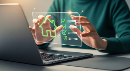 Naklejka premium Person interacting with a digital house checklist on a transparent screen near a laptop display