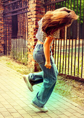 Happy young girl enjoying walking, dancing, jumping. Freestyle. Freedom and carefree. Individuality, alternative lifestyle. Activity summer vacations. Lifestyle photography. Blurred motion