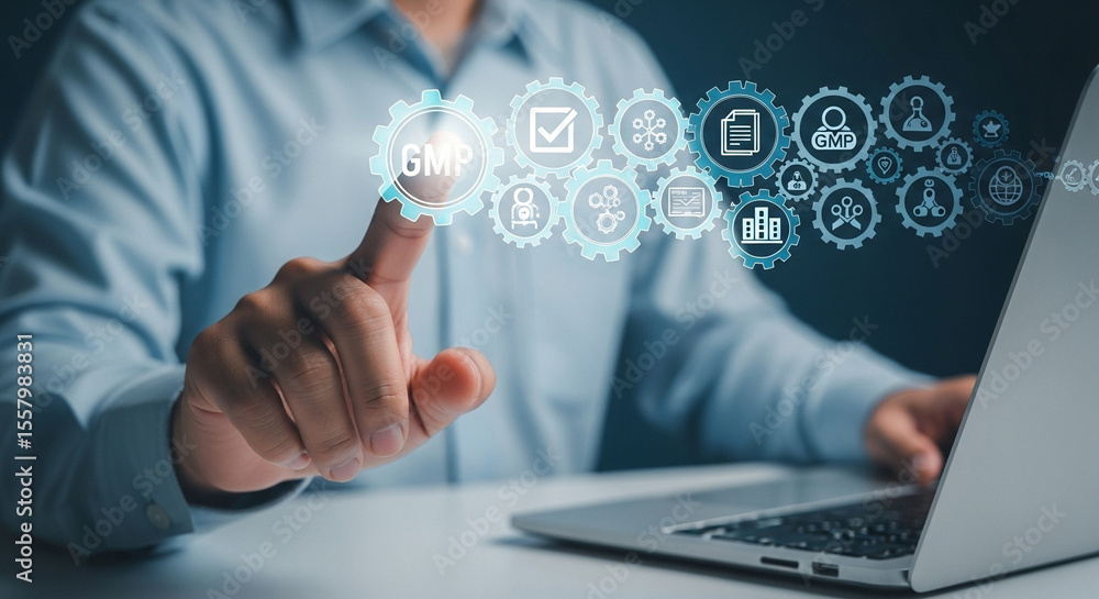 Fototapete Man using laptop with gmp icons and gears hovering above, representing good manufacturing practices