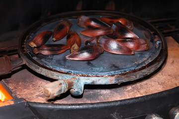 Araucaria pine nut roasted in a rustic way on a hot surface in the fire