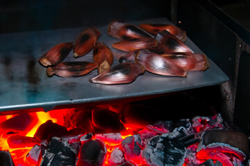 Araucaria pine nut roasted in a rustic way on a hot surface in the fire
