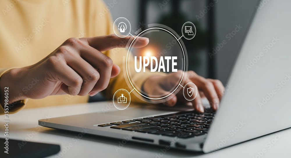 Poster Person updating laptop with icons showing security download and computer features on the screen